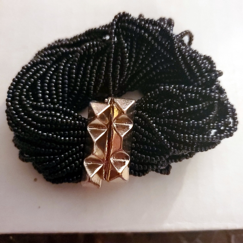 Multistrand black beaded bracelet with gold magnetic closure